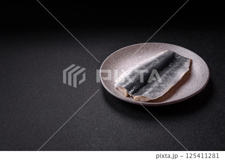 Herring fillet salted and marinated with salt, spices and oil 125411281