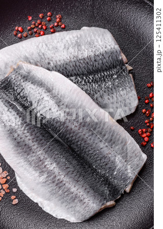 Herring fillet salted and marinated with salt, spices and oil Herring fillet salted and marinated with salt, spices and oil 125411302