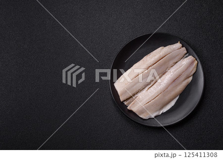 Herring fillet salted and marinated with salt, spices and oil 125411308