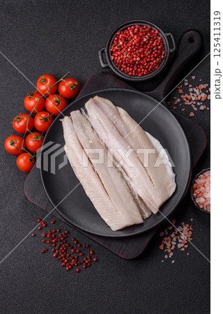 Herring fillet salted and marinated with salt, spices and oil 125411319