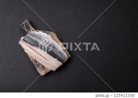 Herring fillet salted and marinated with salt, spices and oil Herring fillet salted and marinated with salt, spices and oil 125411330