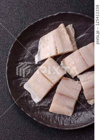 Herring fillet salted and marinated with salt, spices and oil 125411338