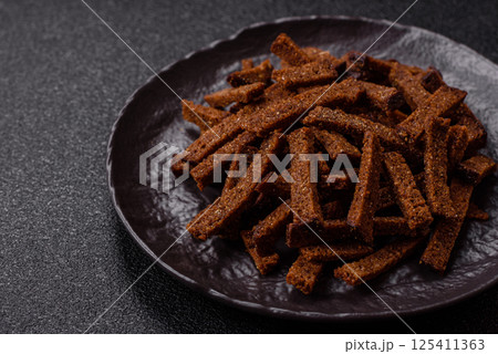Crispy homemade brown bread crackers or croutons with seeds and grains 125411363