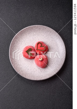 Delicious sweet mochi in the shape of red hearts 125411594
