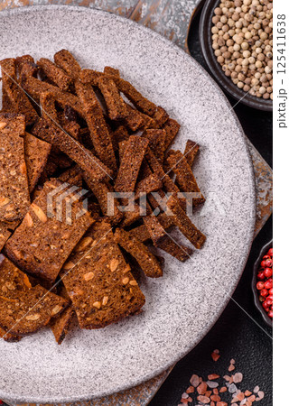 Crispy homemade brown bread crackers or croutons with seeds and grains 125411638