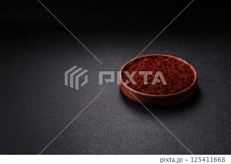 Red thin hot chili threads on a dark background Red thin hot chili threads on a dark background 125411668