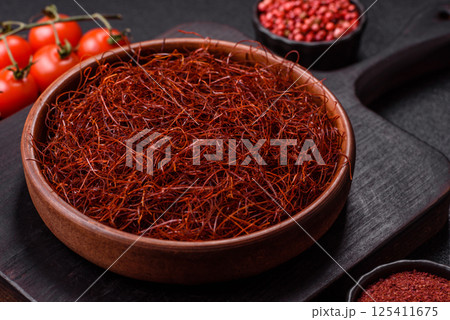 Red thin hot chili threads on a dark background Red thin hot chili threads on a dark background 125411675