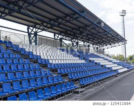 Armchairs seats blue chairs at the sport stadium 125411884