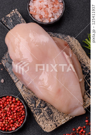Raw chicken or turkey fillet with salt, spices and herbs Raw chicken or turkey fillet with salt, spices and herbs 125411937