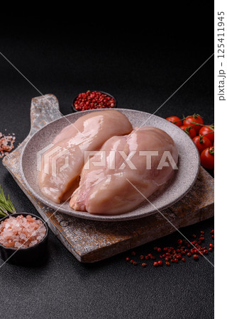 Raw chicken or turkey fillet with salt, spices and herbs 125411945