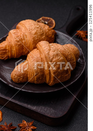 Sweet crispy croissants with chocolate filling 125411996