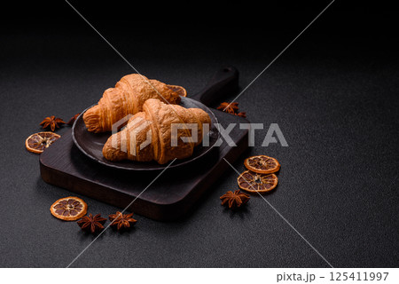 Sweet crispy croissants with chocolate filling 125411997
