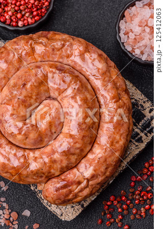 Delicious homemade sausage in the shape of a snail or spiral Delicious homemade sausage in the shape of a snail or spiral 125412063