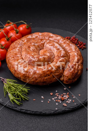 Delicious homemade sausage in the shape of a snail or spiral Delicious homemade sausage in the shape of a snail or spiral 125412077