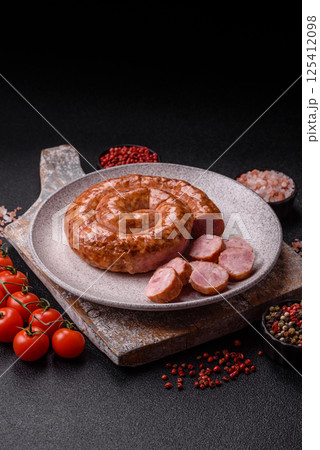 Delicious homemade sausage in the shape of a snail or spiral 125412098