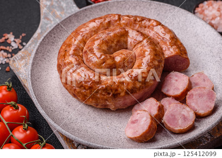 Delicious homemade sausage in the shape of a snail or spiral 125412099