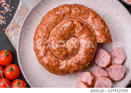 Delicious homemade sausage in the shape of a snail or spiral 125412100