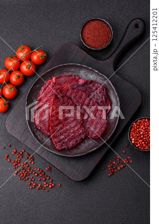 Dried beef slices, jerky, with cherry or plum flavor, salt and spices Dried beef slices, jerky, with cherry or plum flavor, salt and spices 125412201