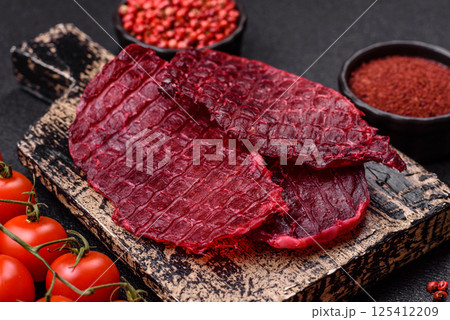 Dried beef slices, jerky, with cherry or plum flavor, salt and spices Dried beef slices, jerky, with cherry or plum flavor, salt and spices 125412209