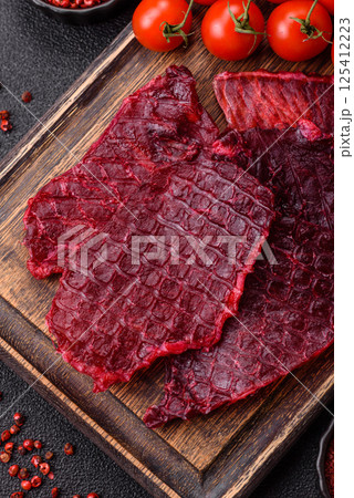 Dried beef slices, jerky, with cherry or plum flavor, salt and spices 125412223