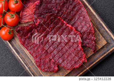 Dried beef slices, jerky, with cherry or plum flavor, salt and spices Dried beef slices, jerky, with cherry or plum flavor, salt and spices 125412226