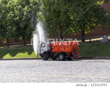 Moscow, Russia May 14, 2024: water-sprinkling machine on Red Square on a hot summer day Moscow, Russia May 14, 2024: water-sprinkling machine on Red Square on a hot summer day 125412455