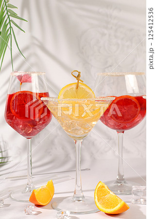 Flyer with various alcoholic drinks with tropical fruits, margarita, aperol sprits cocktail with slices of blood orange, grapefruit, with rum from tequila, rum, vodka and ice. Summer party concept, 125412536