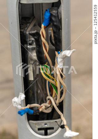 Electrical junction box showing exposed and damaged wiring requiring repair Electrical junction box showing exposed and damaged wiring requiring repair 125412559