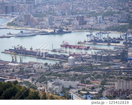 Panoramic view of Novorossiysk City and Tsemess Bay at sunrise. Morning cityscape of large port at Black Sea coast in Russia Panoramic view of Novorossiysk City and Tsemess Bay at sunrise. Morning cityscape of large port at Black Sea coast in Russia 125412819