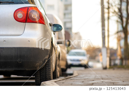 Kyiv, Ukraine - February 16, 2020: Modern cars parked on city street side in residential discrict. Shiny vehicles parked by the curb. Urban transportation infrastructure concept. 125413043