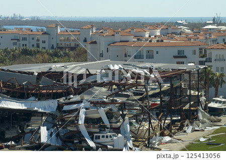 Hurricane Ian destroyed boat station in Florida coastal area. Natural disaster and its consequences 125413056