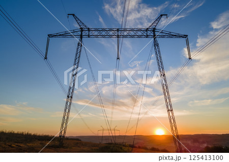 High voltage tower with electric power lines at sunset. Transmission of electricity High voltage tower with electric power lines at sunset. Transmission of electricity 125413100