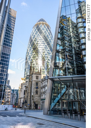 Historic St Andrew Undershaft Church stands gracefully beside the modern Gherkin building in the heart of London. This juxtaposition showcases the blend of old and new architecture in the city. Historic St Andrew Undershaft Church stands gracefully beside the modern Gherkin building in the heart of London. This juxtaposition showcases the blend of old and new architecture in the city. 125413377
