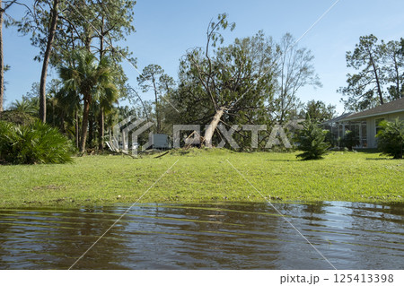 Flooded empty street after hurricane rainfall in Florida residential area. Consequences of natural disaster Flooded empty street after hurricane rainfall in Florida residential area. Consequences of natural disaster 125413398