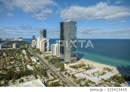 Expensive highrise hotels and condos on Atlantic ocean shore in Sunny Isles Beach city. American tourism infrastructure in southern Florida 125413416