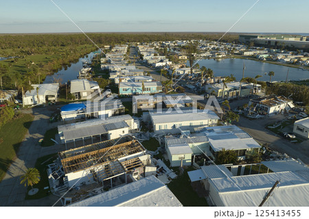 Destroyed by strong hurricane winds suburban houses in Florida mobile home residential area. Consequences of natural disaster Destroyed by strong hurricane winds suburban houses in Florida mobile home residential area. Consequences of natural disaster 125413455