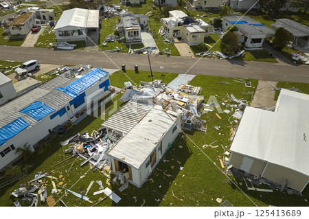 Badly damaged mobile homes after hurricane Ian in Florida residential area. Consequences of natural disaster 125413689