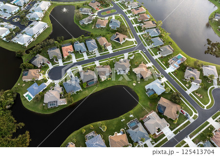 American gated community houses in rural US suburbs. View from above of large residential homes in small town in southwest Florida American gated community houses in rural US suburbs. View from above of large residential homes in small town in southwest Florida 125413704