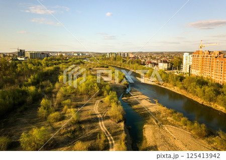 Aerial view of tall residential apartment buildings under construction and Bystrytsia river in Ivano-Frankivsk city, Ukraine. Aerial view of tall residential apartment buildings under construction and Bystrytsia river in Ivano-Frankivsk city, Ukraine. 125413942
