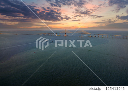 Aerial view of Sunshine Skyway Bridge over Tampa Bay in Florida with moving traffic. Concept of transportation infrastructure Aerial view of Sunshine Skyway Bridge over Tampa Bay in Florida with moving traffic. Concept of transportation infrastructure 125413943