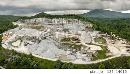 Aerial view of open pit mining site of limestone materials extraction for construction industry 125414016