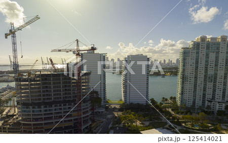 Aerial view of new developing residense in american urban area. Tower cranes at industrial construction site in Miami, Florida. Concept of housing growth in the USA 125414021