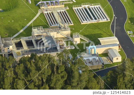 Aerial view of modern water cleaning facility at urban wastewater treatment plant. Purification process of removing undesirable chemicals, suspended solids and gases from contaminated liquid Aerial view of modern water cleaning facility at urban wastewater treatment plant. Purification process of removing undesirable chemicals, suspended solids and gases from contaminated liquid 125414023