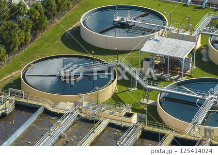 Aerial view of modern water cleaning facility at urban wastewater treatment plant. Purification process of removing undesirable chemicals, suspended solids and gases from contaminated liquid Aerial view of modern water cleaning facility at urban wastewater treatment plant. Purification process of removing undesirable chemicals, suspended solids and gases from contaminated liquid 125414024