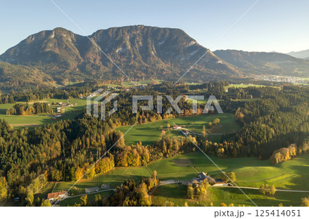 Aerial view of green meadows with villages and forest in austrian Alps mountains. Aerial view of green meadows with villages and forest in austrian Alps mountains. 125414051