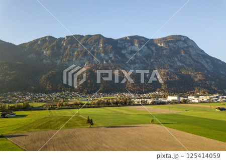 Aerial view of green meadows with villages and forest in austrian Alps mountains. Aerial view of green meadows with villages and forest in austrian Alps mountains. 125414059