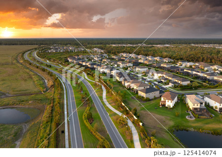 Aerial view of expensive residential houses in small town in southwest Florida. American dream homes as example of real estate development in US suburbs Aerial view of expensive residential houses in small town in southwest Florida. American dream homes as example of real estate development in US suburbs 125414074