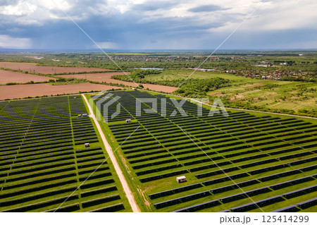 Aerial view of big sustainable electric power plant with many rows of solar photovoltaic panels for producing clean ecological electrical energy. Renewable electricity with zero emission concept. 125414299