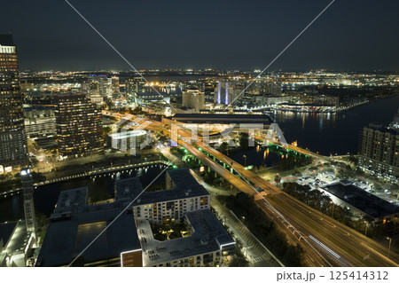 Aerial view of american highway junction at night with fast driving vehicles in Tampa, Florida. View from above of USA transportation infrastructure Aerial view of american highway junction at night with fast driving vehicles in Tampa, Florida. View from above of USA transportation infrastructure 125414312