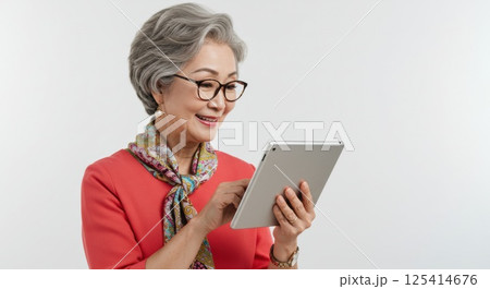 タブレットを使いこなす日本人シニア女性（ai生成画像） 125414676